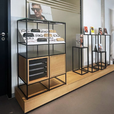 Modular eyewear display with storage, drawers and additional brochure holders.